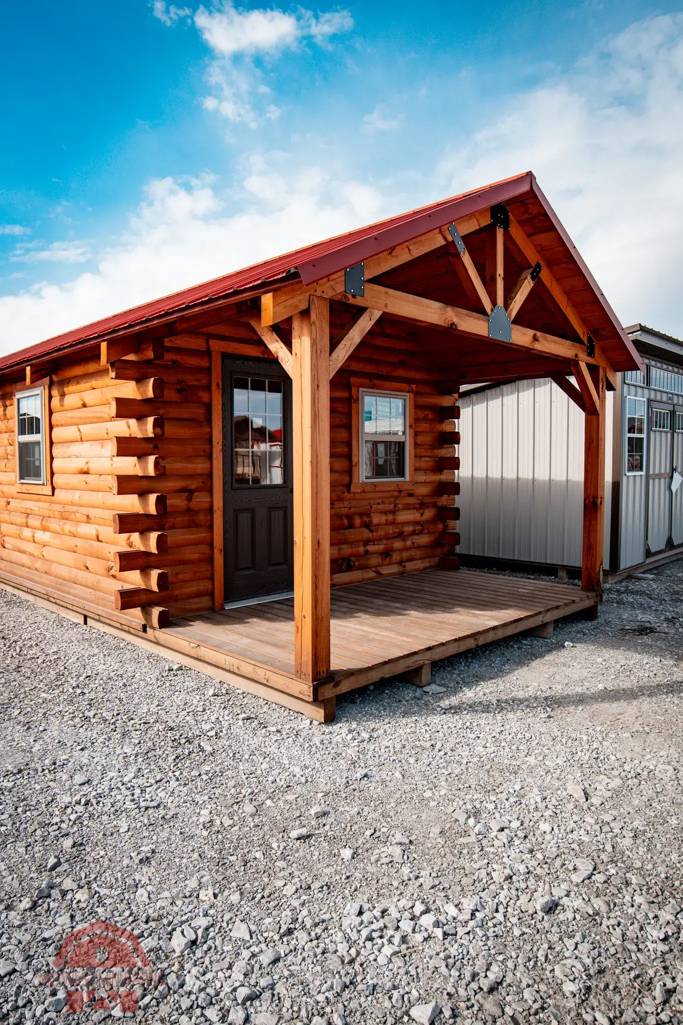 Log cabin with a covered porch built by Midwest Mini Barns in Winston, Missouri