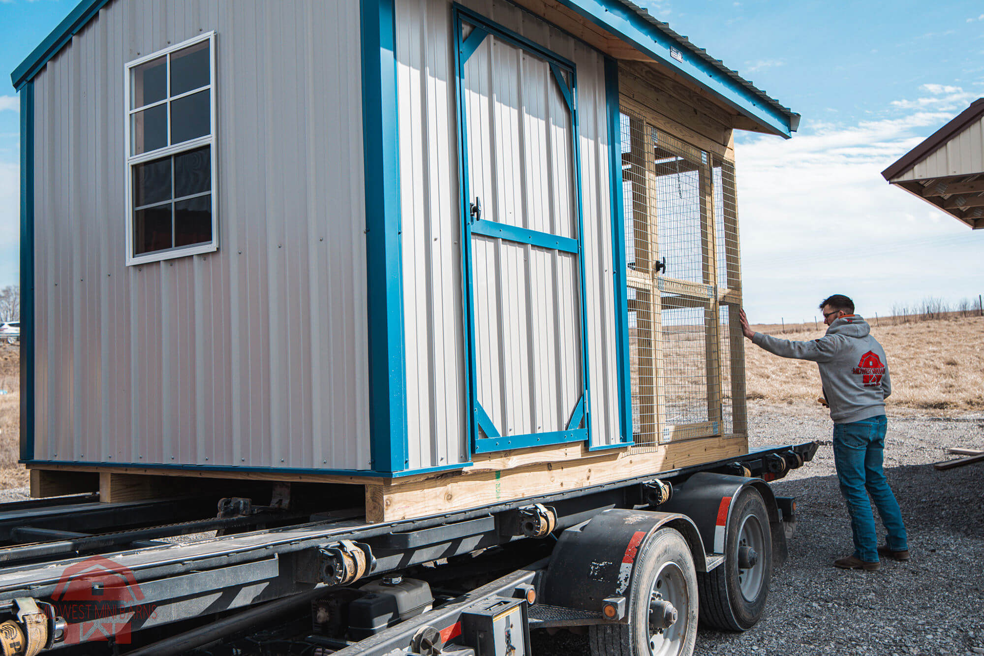 Midwest Mini Barns delivery truck hauling a shed to a Missouri property